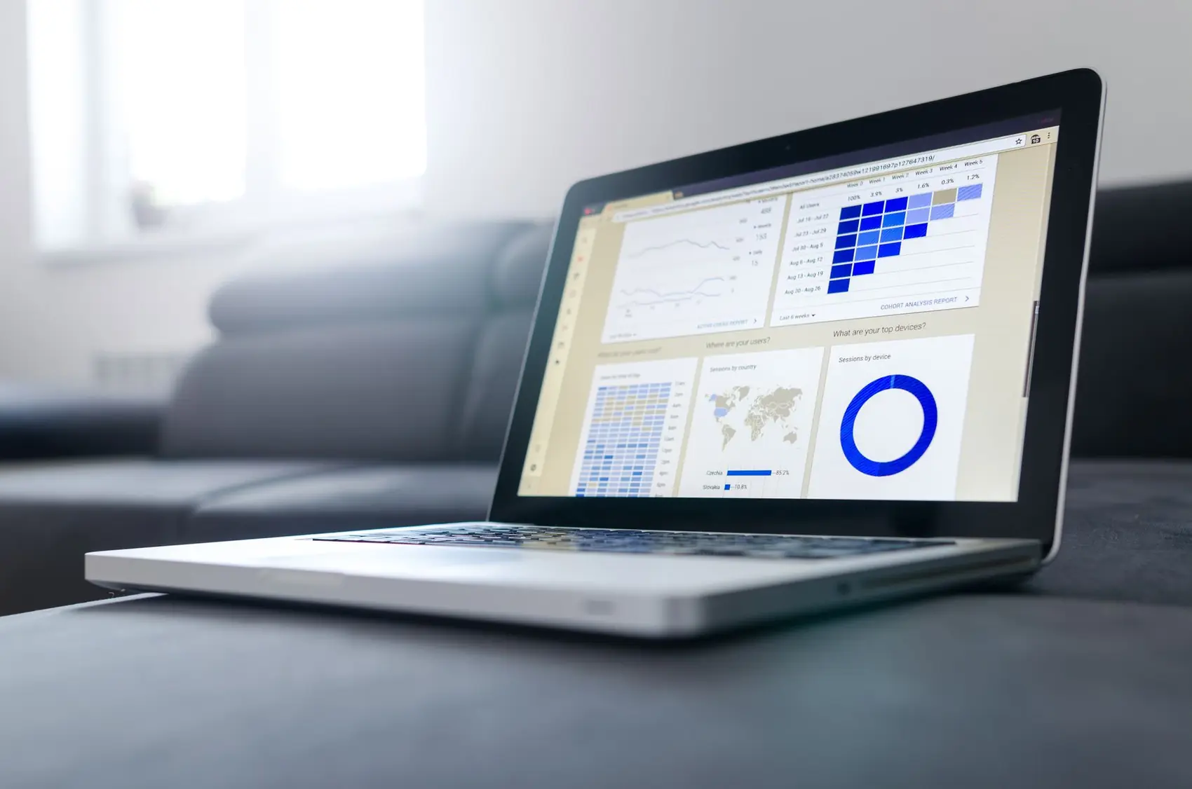 An analyst reviewing customer and loan reports on two screens